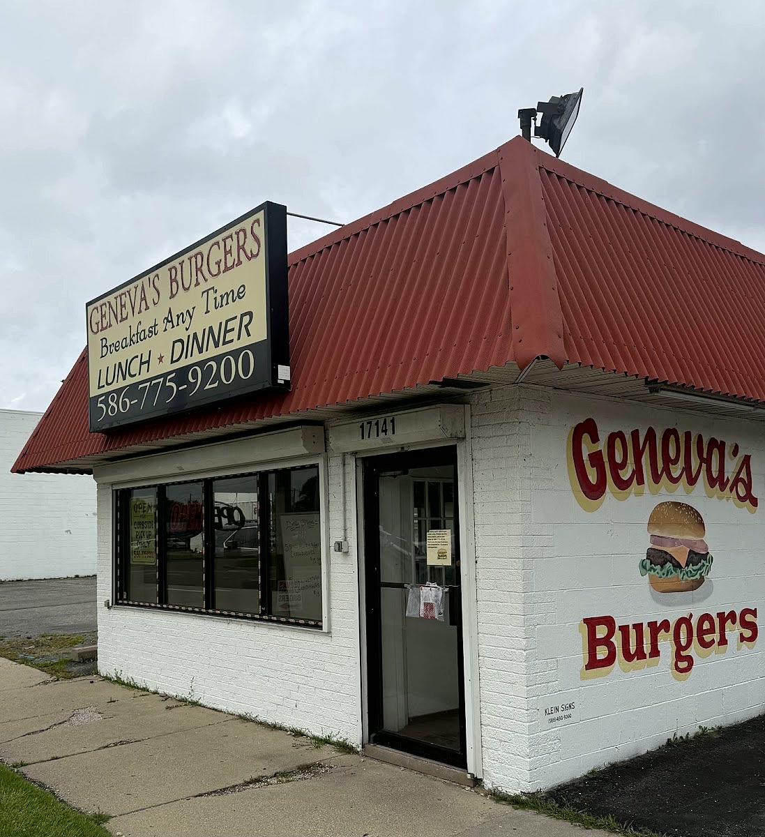 The front of Geneva's Burgers on 8 Mile Road, red roof and the sign reading breakfast any time.