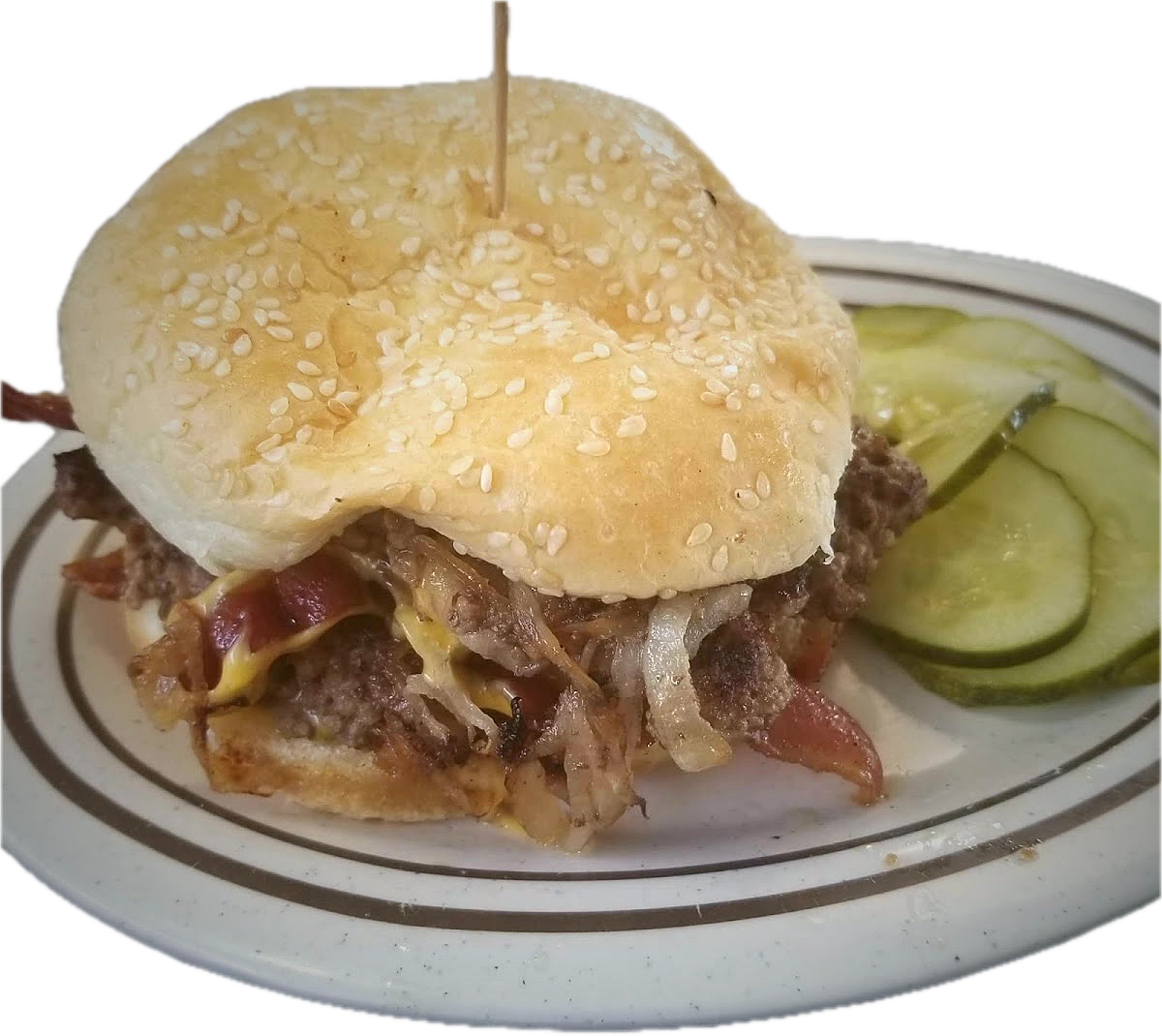 A Geneva's bacon cheeseburger with grilled onions on a sesame bun, served on a diner plate with pickles.