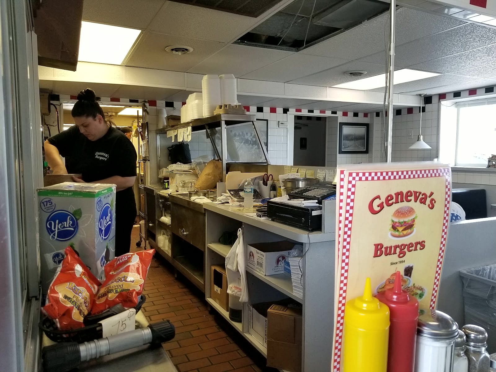 A cook working the flat top in the kitchen at Geneva's.